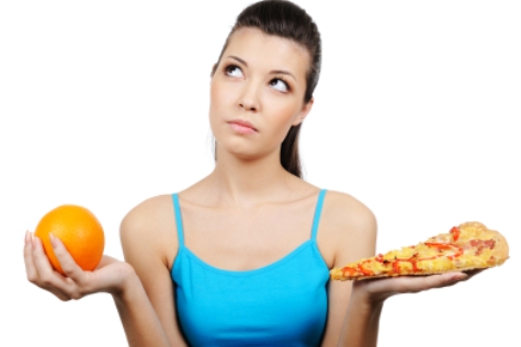 beautiful young woman choosing between pizza and orange